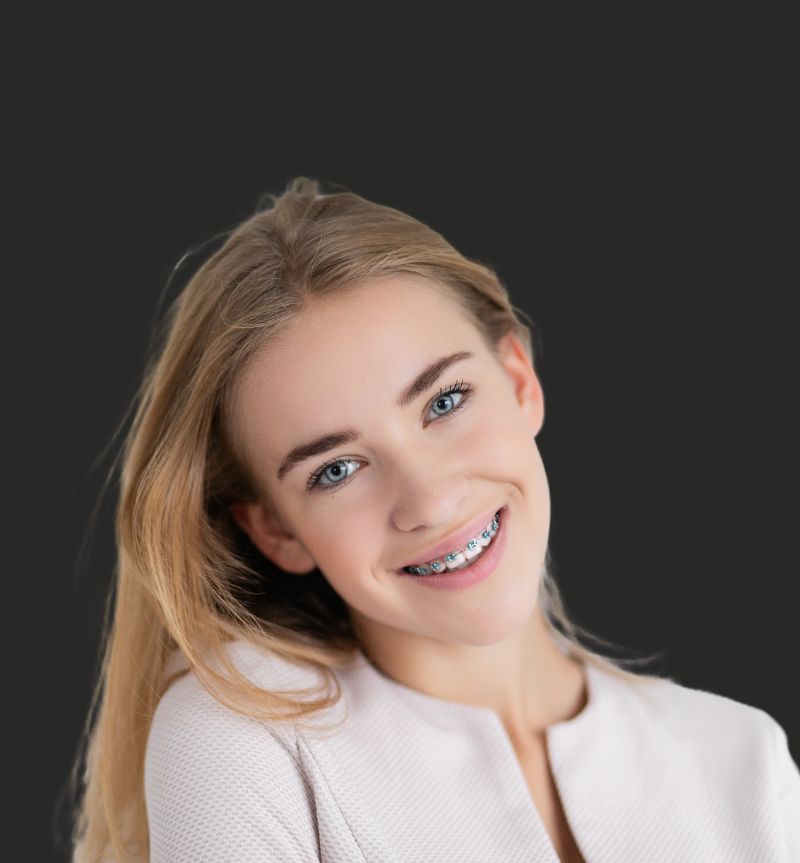 Girl Smiling with traditional metal braces